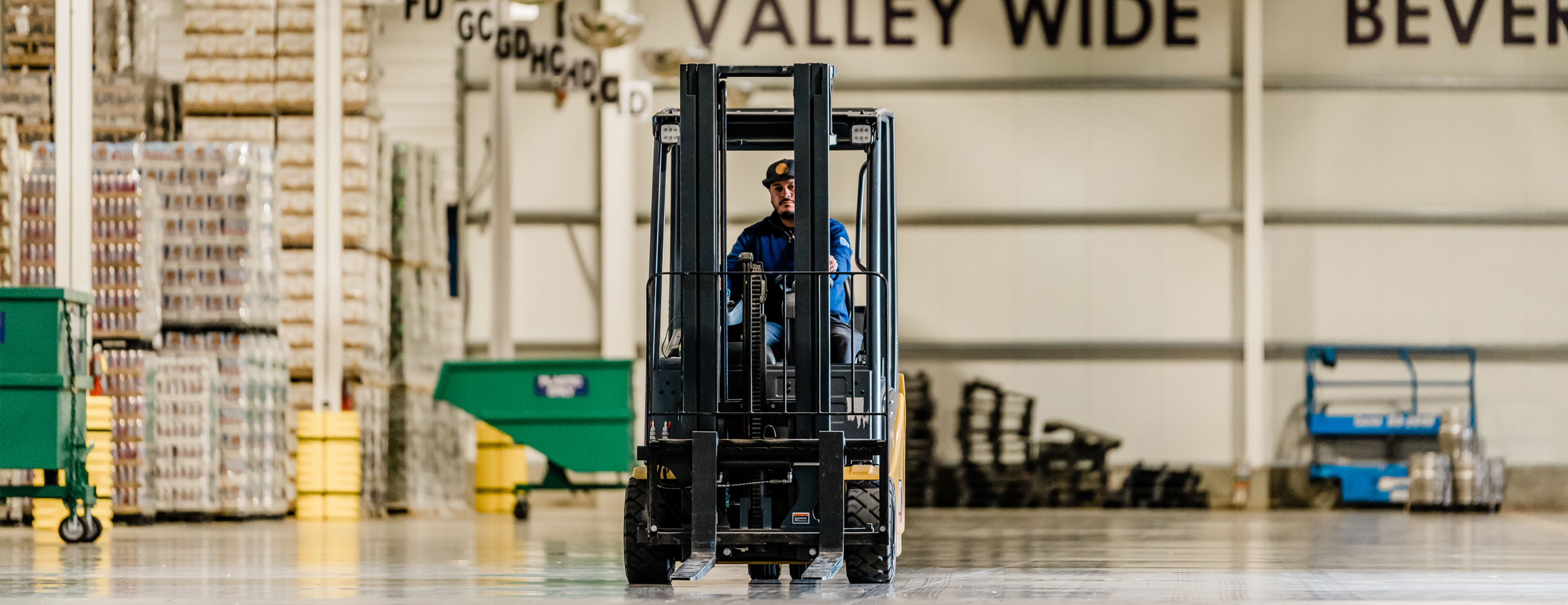 Employees working at VWB Warehouse with forklift